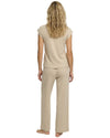 Woman wearing a beige long pajama set