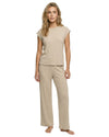 Woman wearing a ribbed beige t-shirt and long pants 