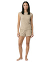 Woman wearing a beige sleeveless top and shorts 