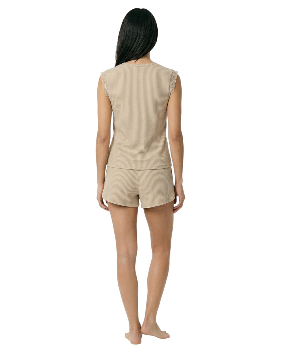 Woman wearing a beige sleeveless top and shorts set 