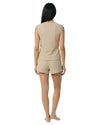 Woman wearing a beige sleeveless top and shorts set 