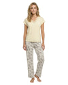 Woman wearing a yellow top and patterned pants 
