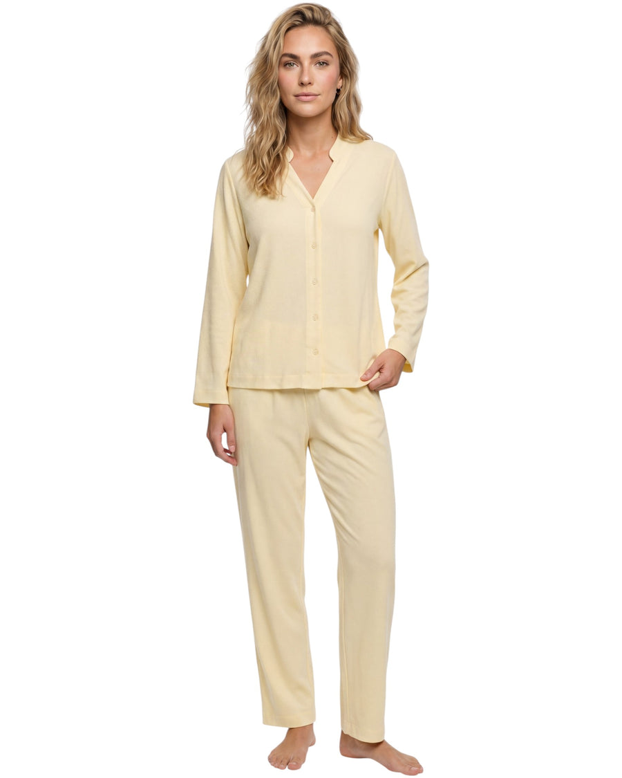 Model wearing a cream long sleeve pajama set with a button-down top and relaxed straight-leg pants.