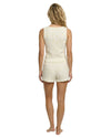 Woman wearing a cream-colored sleeveless top and shorts set with a lemon print