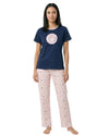 Woman wearing a navy blue t-shirt with a pink graphic and light pink pajama pants