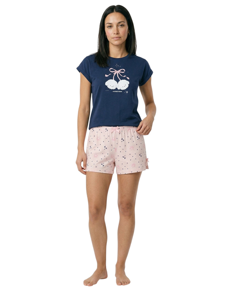 Woman wearing a navy blue t-shirt and pink shorts 