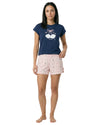 Woman wearing a navy blue t-shirt and pink shorts 