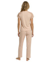 Woman wearing a nude blush pajama set 