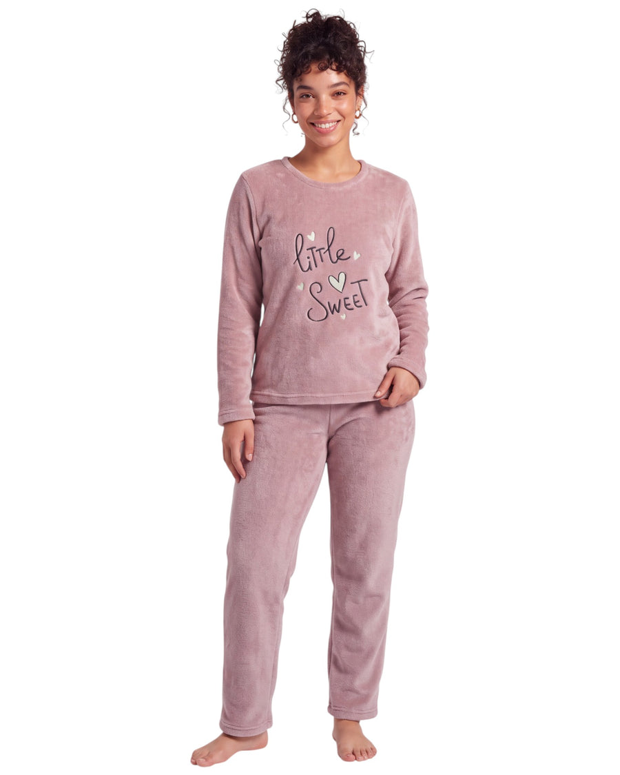 Woman wearing a dusty pink plush long pajama set featuring a round-neck top with a Little Sweet heart print, long sleeves, and matching straight-leg pants.