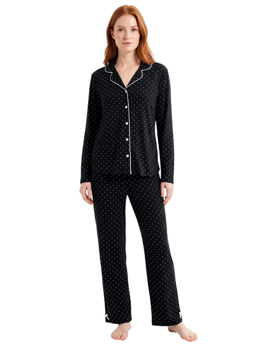 Woman wearing a black dots pajama set long sleeve 
