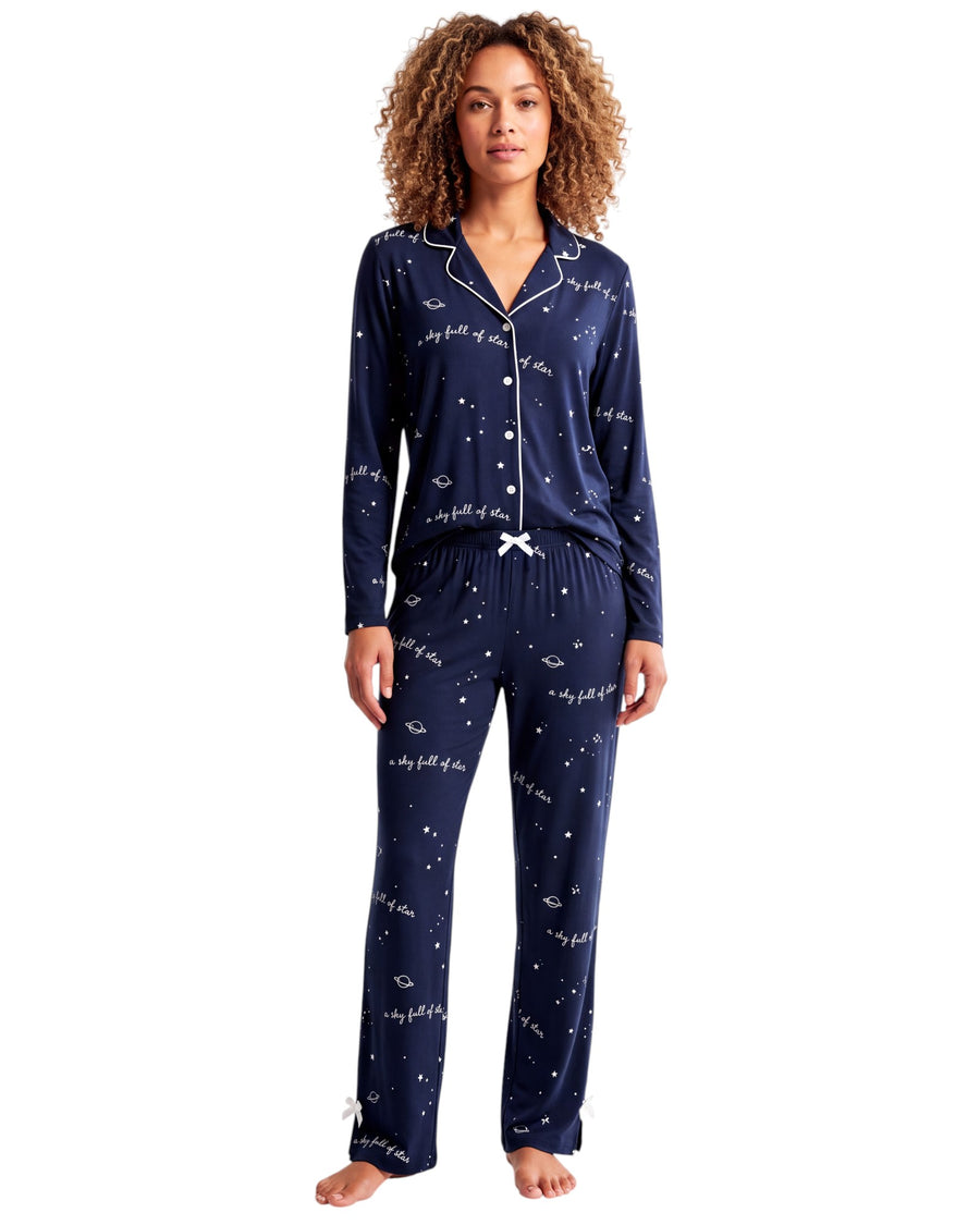 A navy blue long-sleeve pajama top with a white star and script print