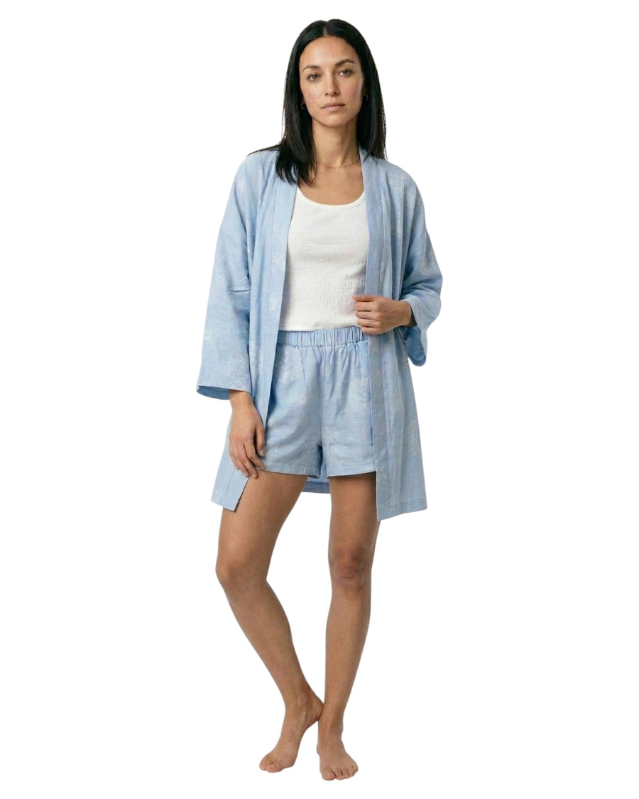 Woman wearing a light blue robe and shorts set with sun print