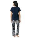 Woman wearing a navy blue t-shirt and patterned pants 