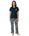 Woman wearing a navy t-shirt and patterned pants