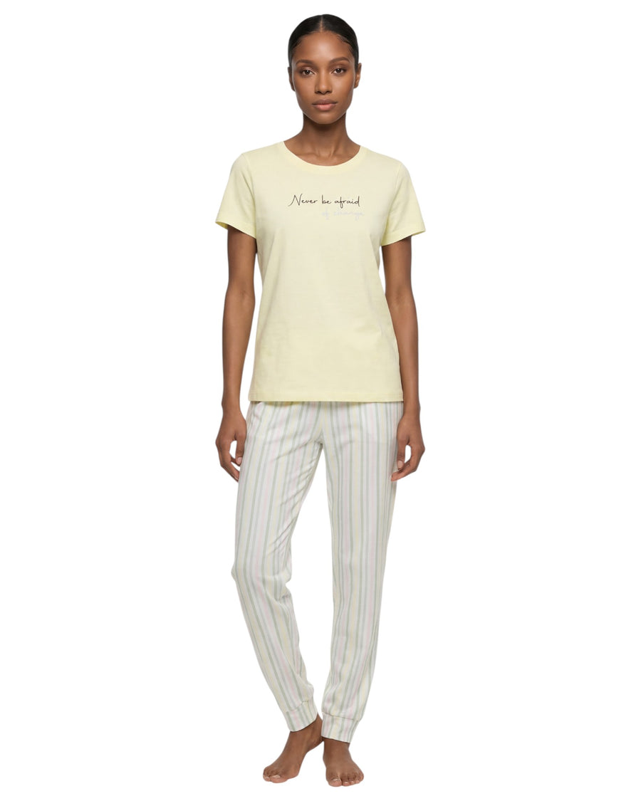 Woman wearing a light yellow t-shirt and white striped pants