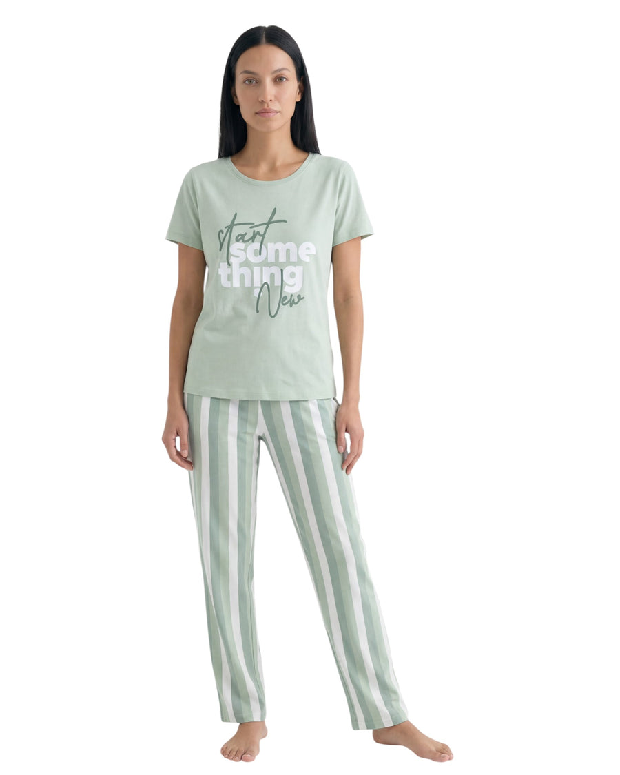 Woman wearing a light green t-shirt and striped pants 