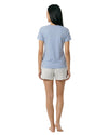 Woman wearing a light blue t-shirt and patterned shorts