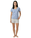 Woman wearing a light blue t-shirt and patterned shorts 