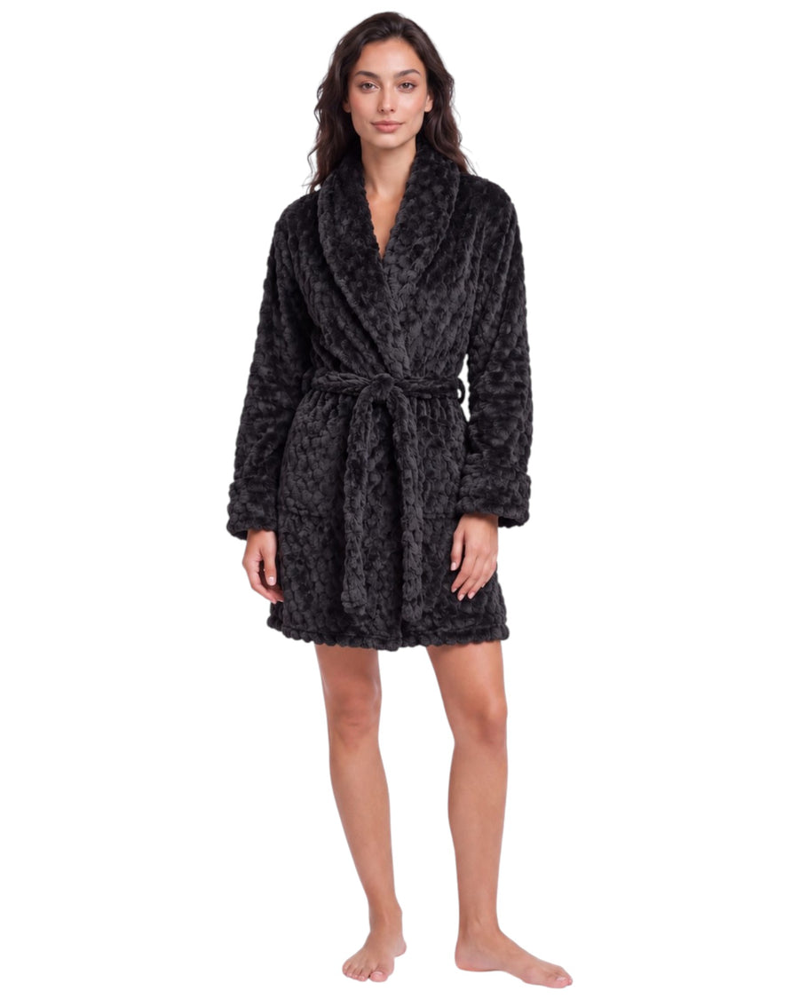 Woman wearing a dark charcoal textured plush short robe with a shawl collar, long sleeves, matching waist belt, and side pockets