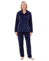 Woman wearing a navy blue plush pajama set featuring a long-sleeve top with a textured collar, buttoned neckline, matching cuffs, and textured long pants.