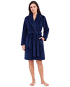 Woman wearing a navy blue textured plush short robe with a shawl collar, waist tie belt, and side pockets.