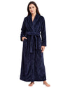 Woman wearing a textured plush long robe featuring long sleeves, a shawl collar, side pockets, and an adjustable waist belt.