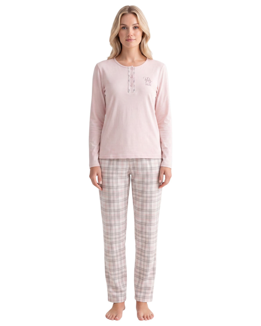 A woman modeling a two-piece pajama set consisting of a light pink long-sleeve henley top and beige plaid pants