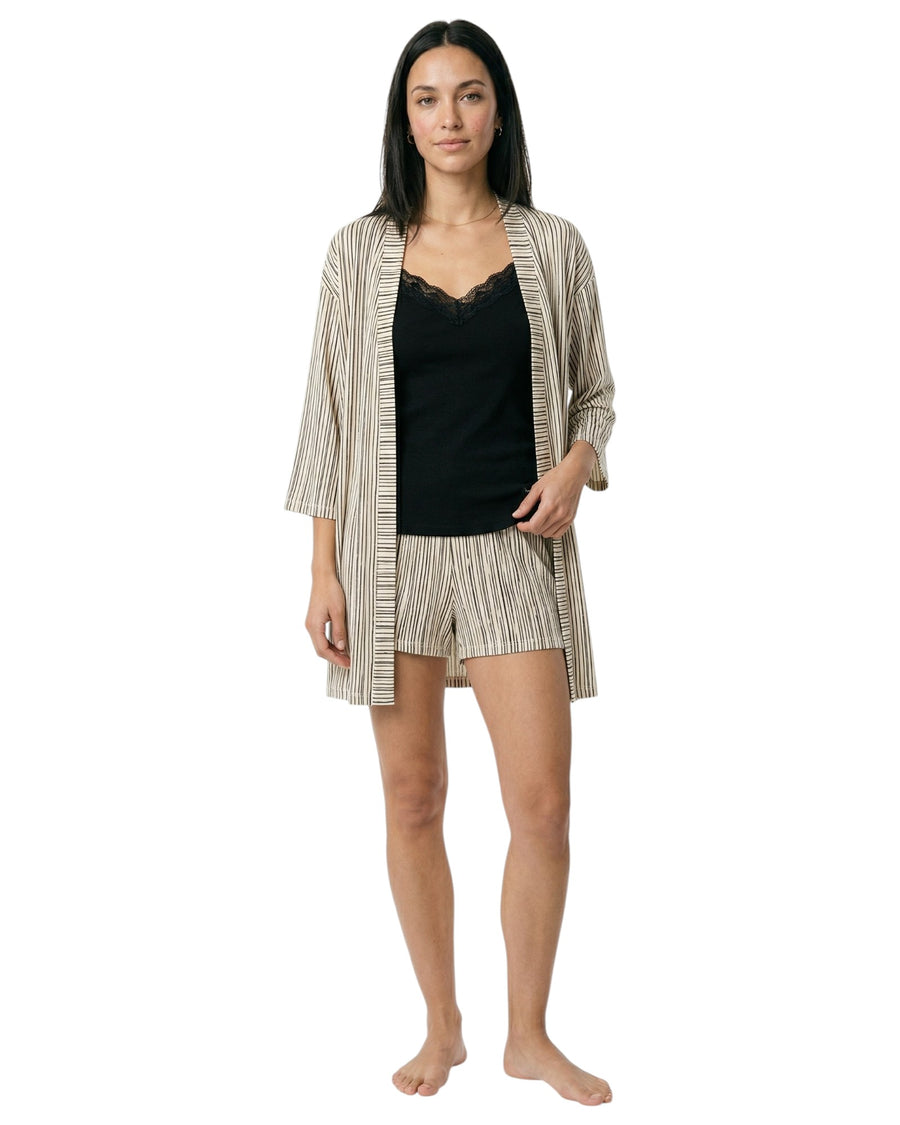 Woman wearing a black top and striped robe with matching shorts