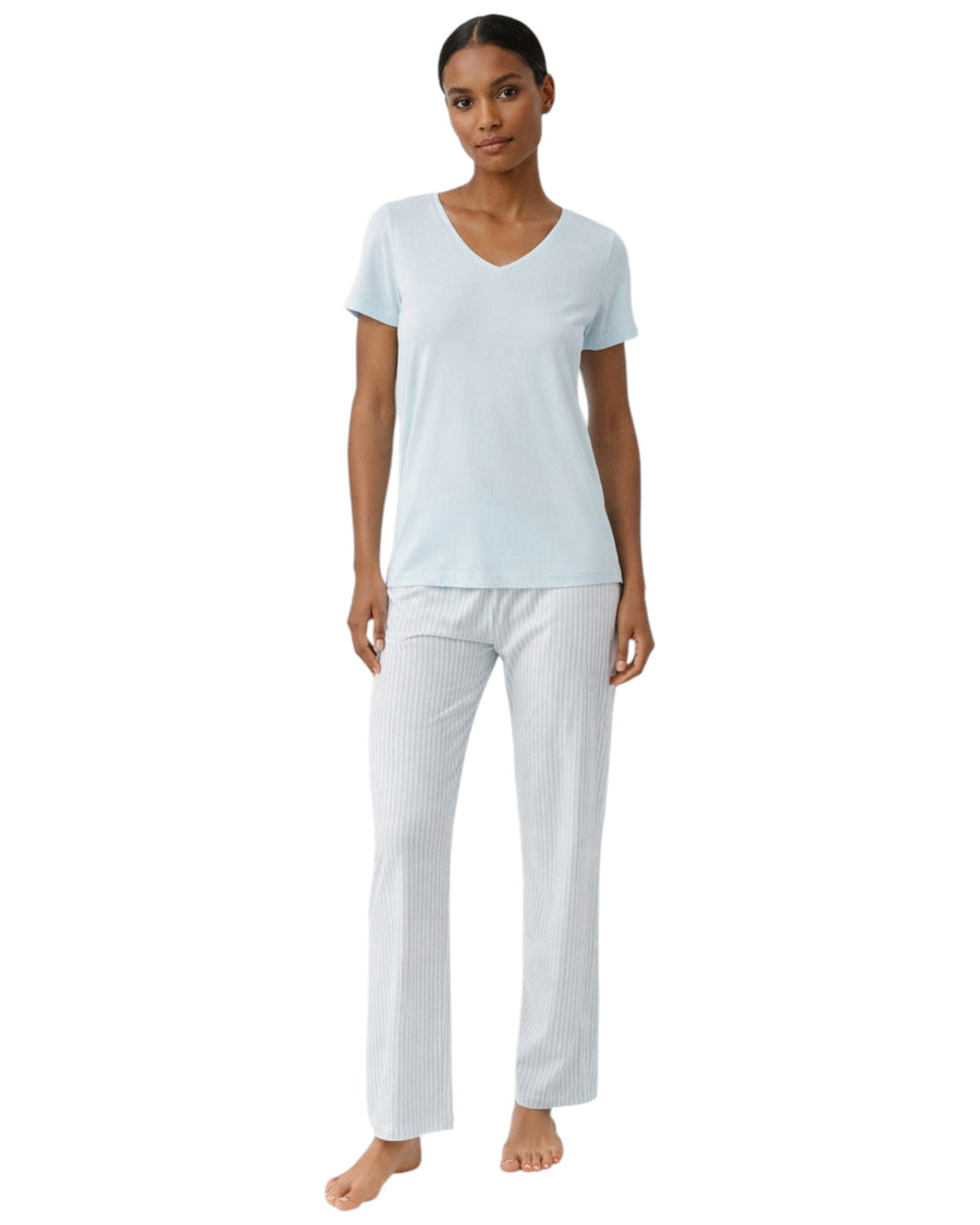 Woman wearing a light blue top and blue striped pants
