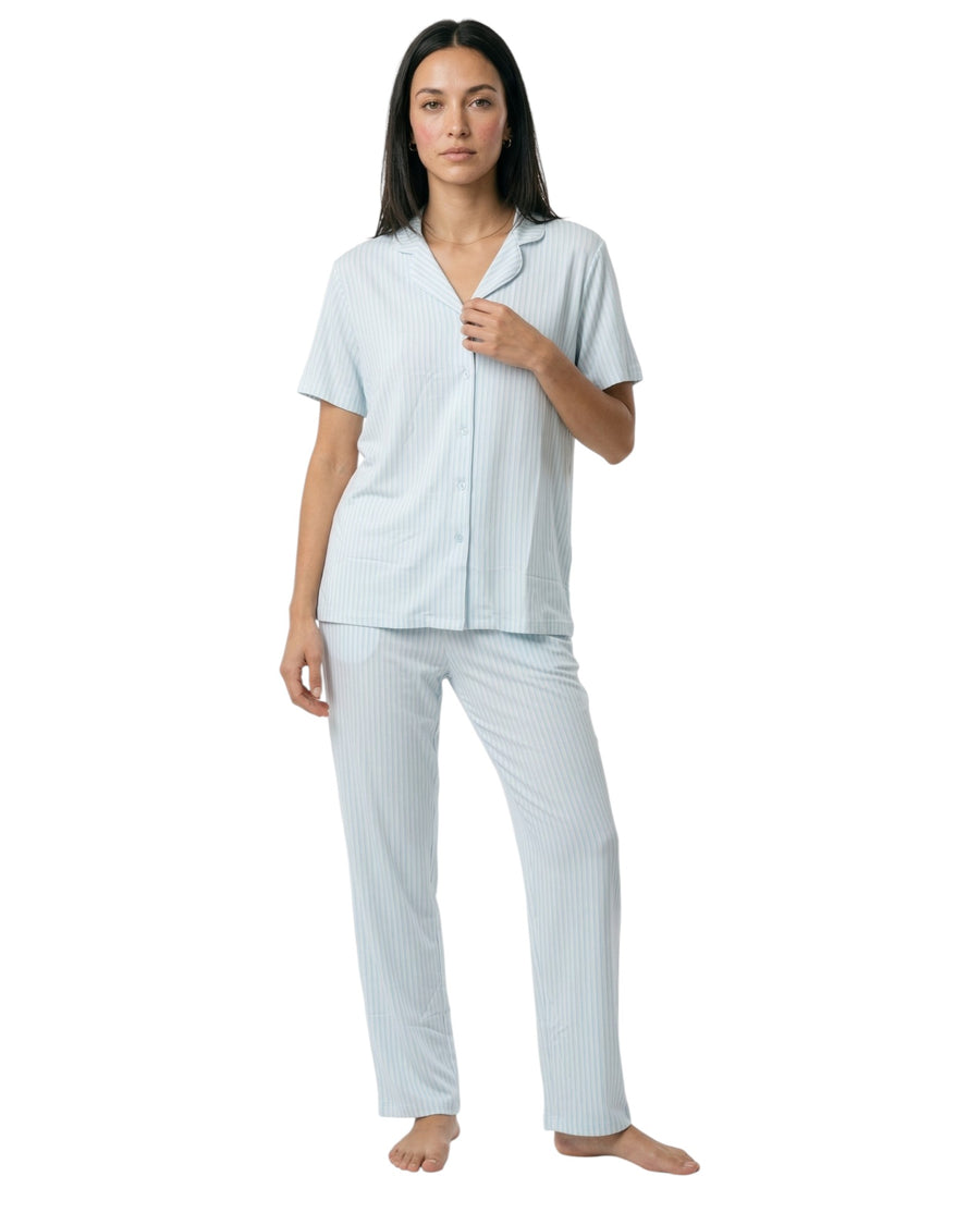 Woman wearing a light blue striped pajama set 