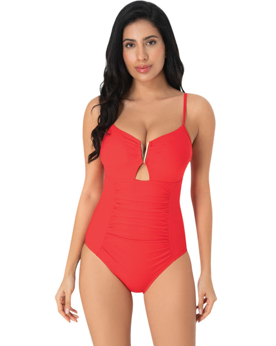 Model wearing a red one-piece swimsuit with plunging neckline, gold bar detail, front keyhole, and ruched waist