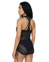 Woman wearing a black sheer mesh halter swim cover-up dress
