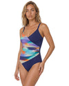 Model wearing a navy blue one-piece swimsuit with abstract multicolor wrap-effect print and adjustable shoulder straps.