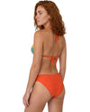 Model wearing a tropical triangle bikini set with turquoise leaf-print top, orange tie straps, and matching orange bikini bottom.