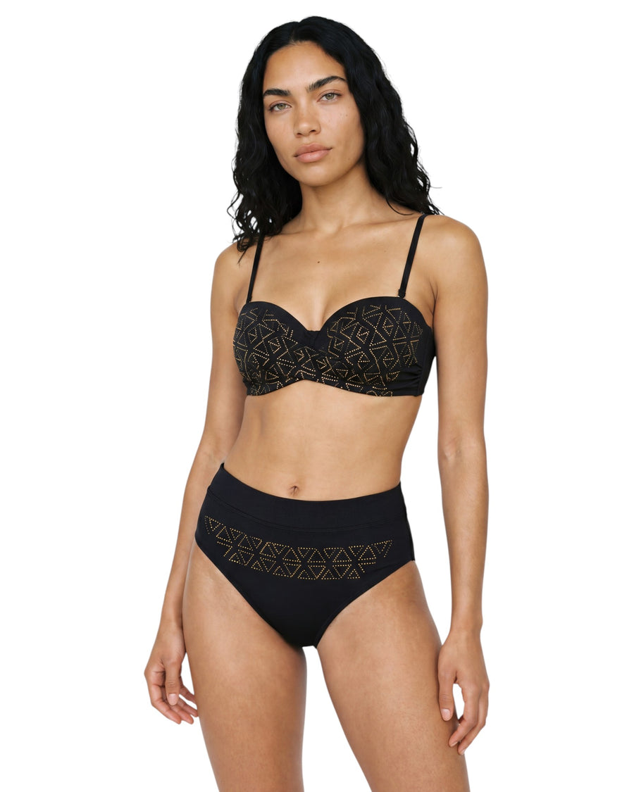 Model wearing a black high-waist bikini set with gold geometric print, structured bandeau-style top, and elegant retro-inspired silhouette.