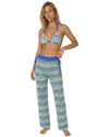 Model wearing crochet stripe beach cover-up pants with a relaxed wide-leg silhouette and adjustable side tie details over swimwear.