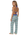Model wearing crochet stripe beach cover-up pants with a relaxed wide-leg silhouette and adjustable side tie details over swimwear.