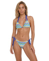 Model wearing a crochet print string bikini set with triangle top and tie-side bottoms in blue, green, and white tones.