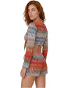 Model wearing multicolor knit beach cover-up shorts with a relaxed fit and vibrant zigzag pattern in pink, blue, red, and neutral tones.