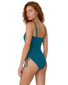 Model wearing a teal one-piece swimsuit with adjustable side ties and gold starfish strap details.