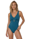 Model wearing a teal one-piece swimsuit with a V-neckline, gold-tone front detail, adjustable straps, and smooth fitted silhouette.