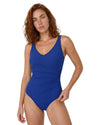 Woman wearing a cobalt blue ruched one piece swimsuit with adjustable straps and a flattering V-neck design.