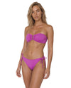Woman wearing a pink bandeau bikini set with gathered front detail, center U-bar accent