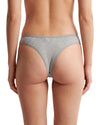 Women's grey ribbed cotton low-rise thong with delicate lace accents, soft stretch fabric, and minimal back coverage for everyday comfort.