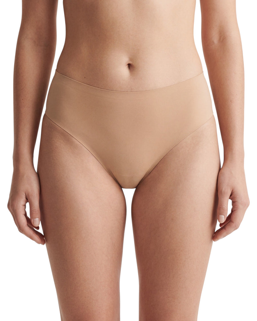 Women's nude seamless mid-rise brief featuring laser-cut edges, full back coverage, and a smooth invisible finish for everyday wear.