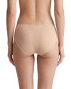 Women's nude seamless mid-rise brief featuring laser-cut edges, full back coverage, and a smooth invisible finish for everyday wear.