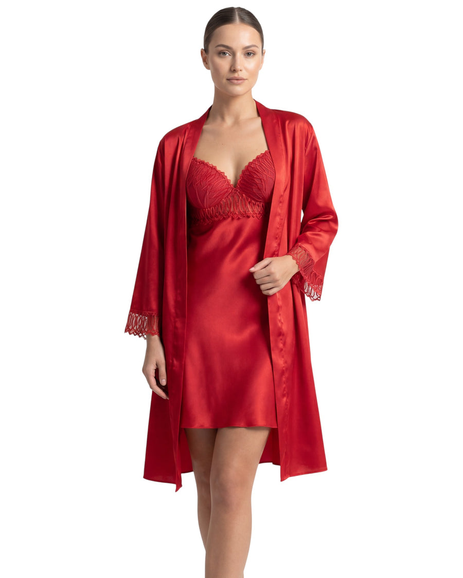 Woman wearing a red satin robe and bra on a white background