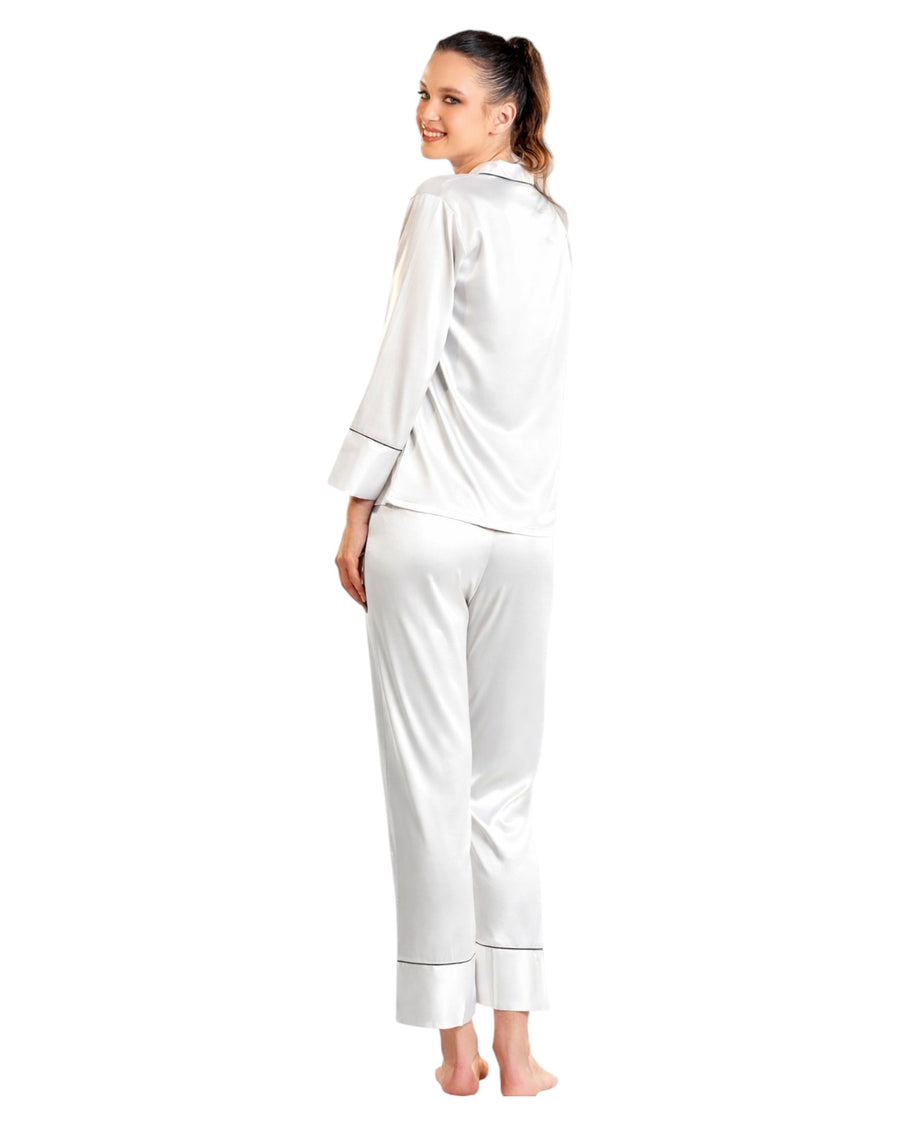 Woman wearing a white satin pajama set 
