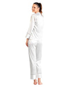 Woman wearing a white satin pajama set 