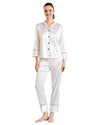 Woman wearing a white satin pajama set